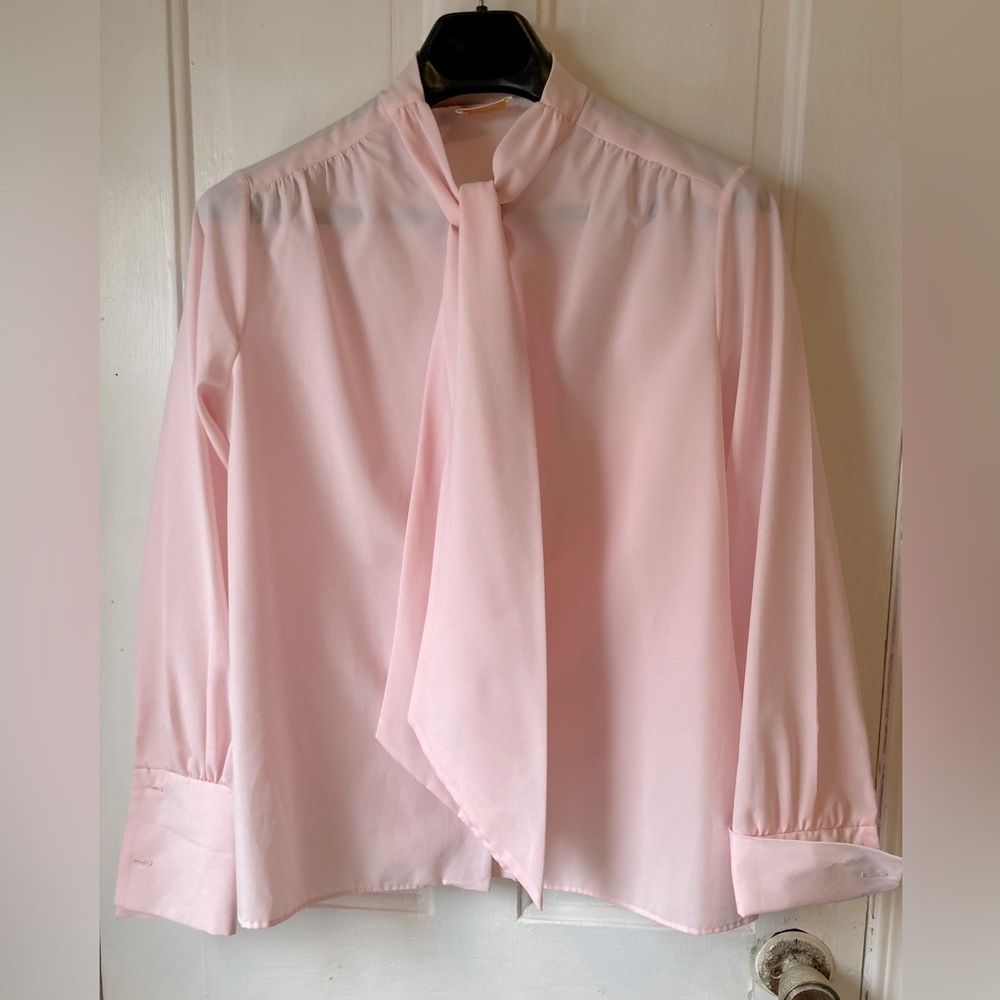 Vintage pink blouse. Pearlized buttons, tie neck. Good condition.